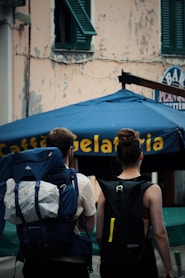 A couple of people walking down a street
