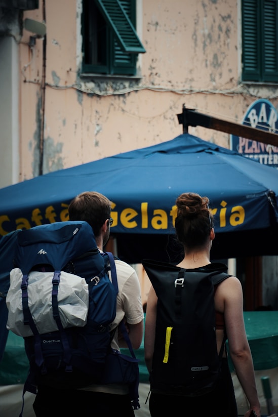 A couple of people walking down a street