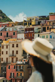 A woman with a hat looking at a city