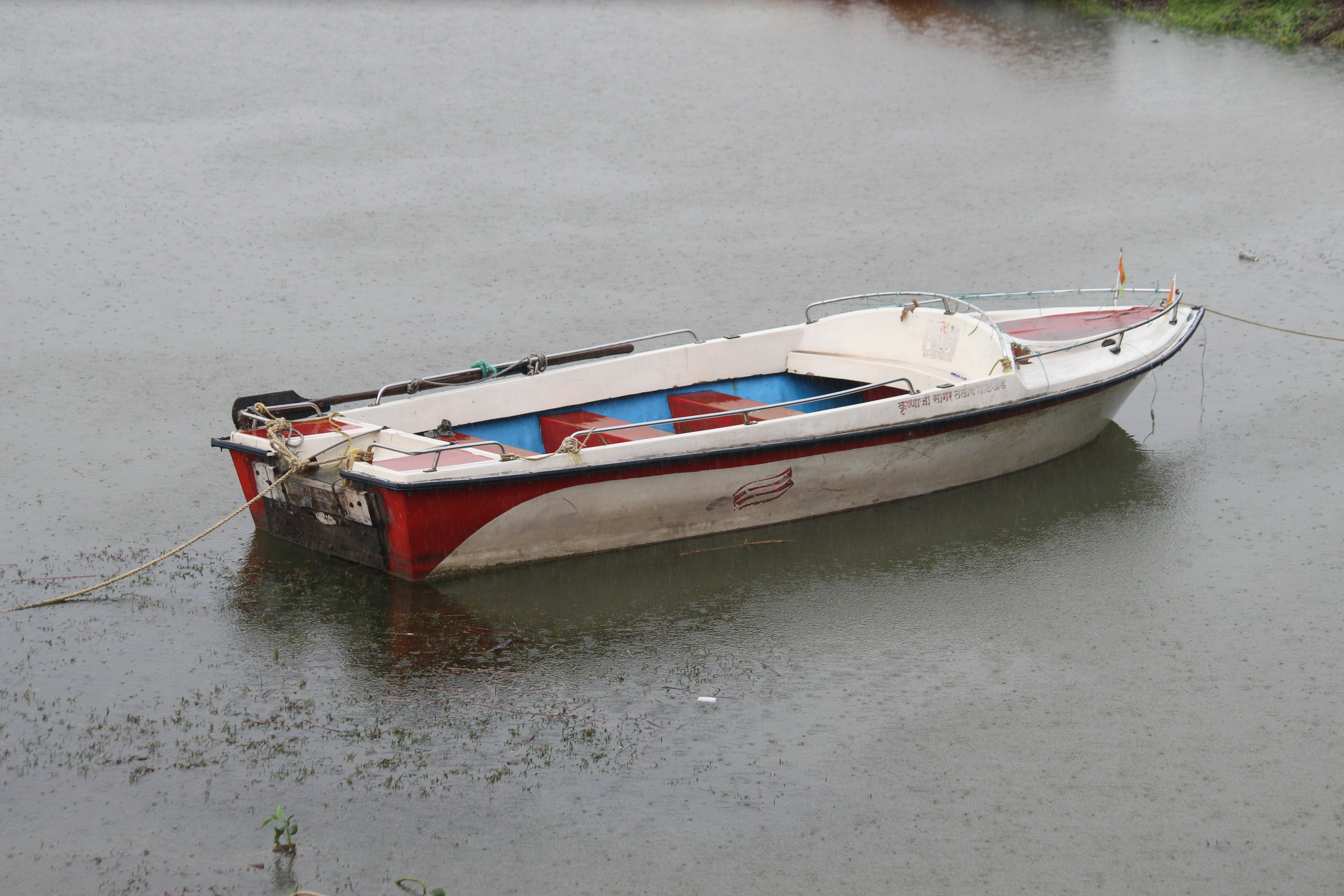 A small boat floating on top of a body of water
