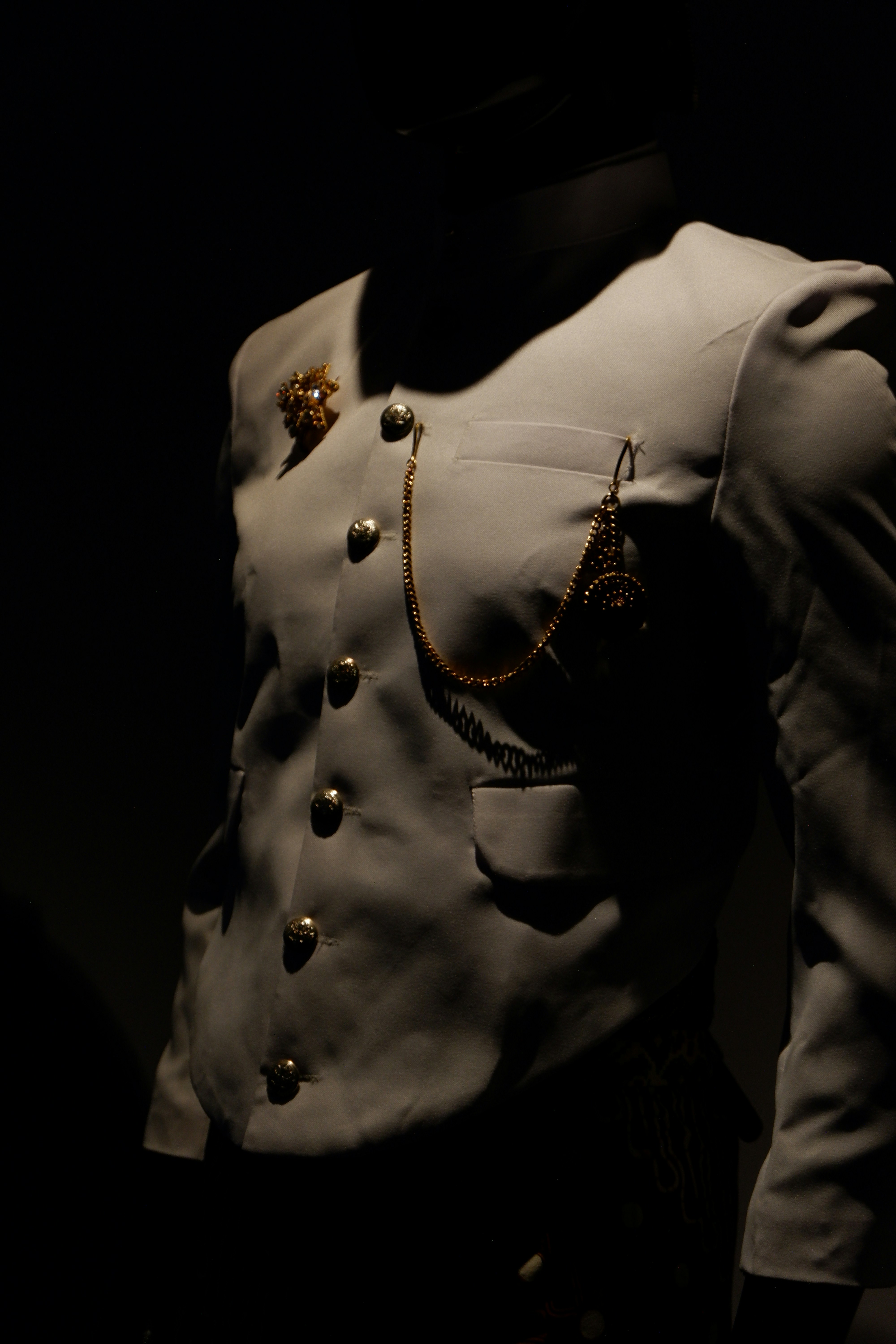 A mannequin dressed in a military uniform in a dark room