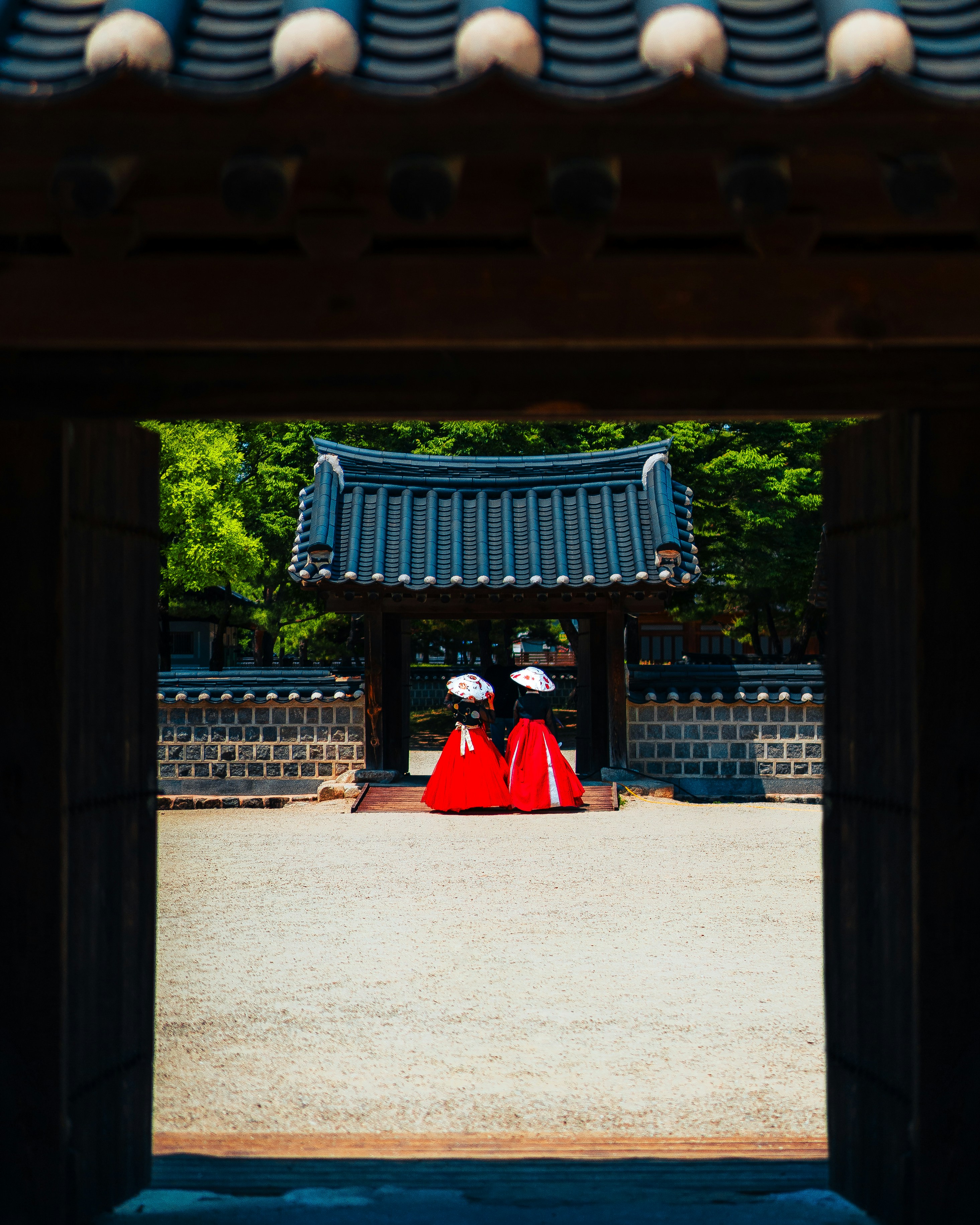 A couple of people that are standing in front of a building