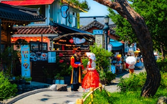 A woman in a red dress walking down a street