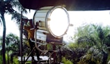 A man sitting in a chair with a light on top of it