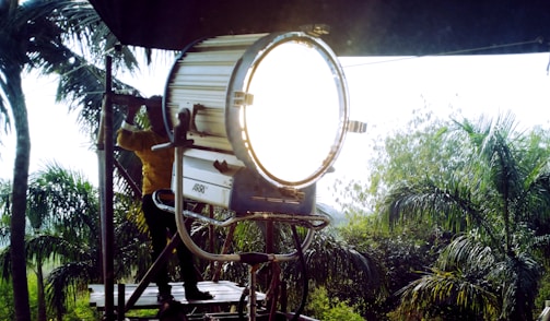 A man sitting in a chair with a light on top of it