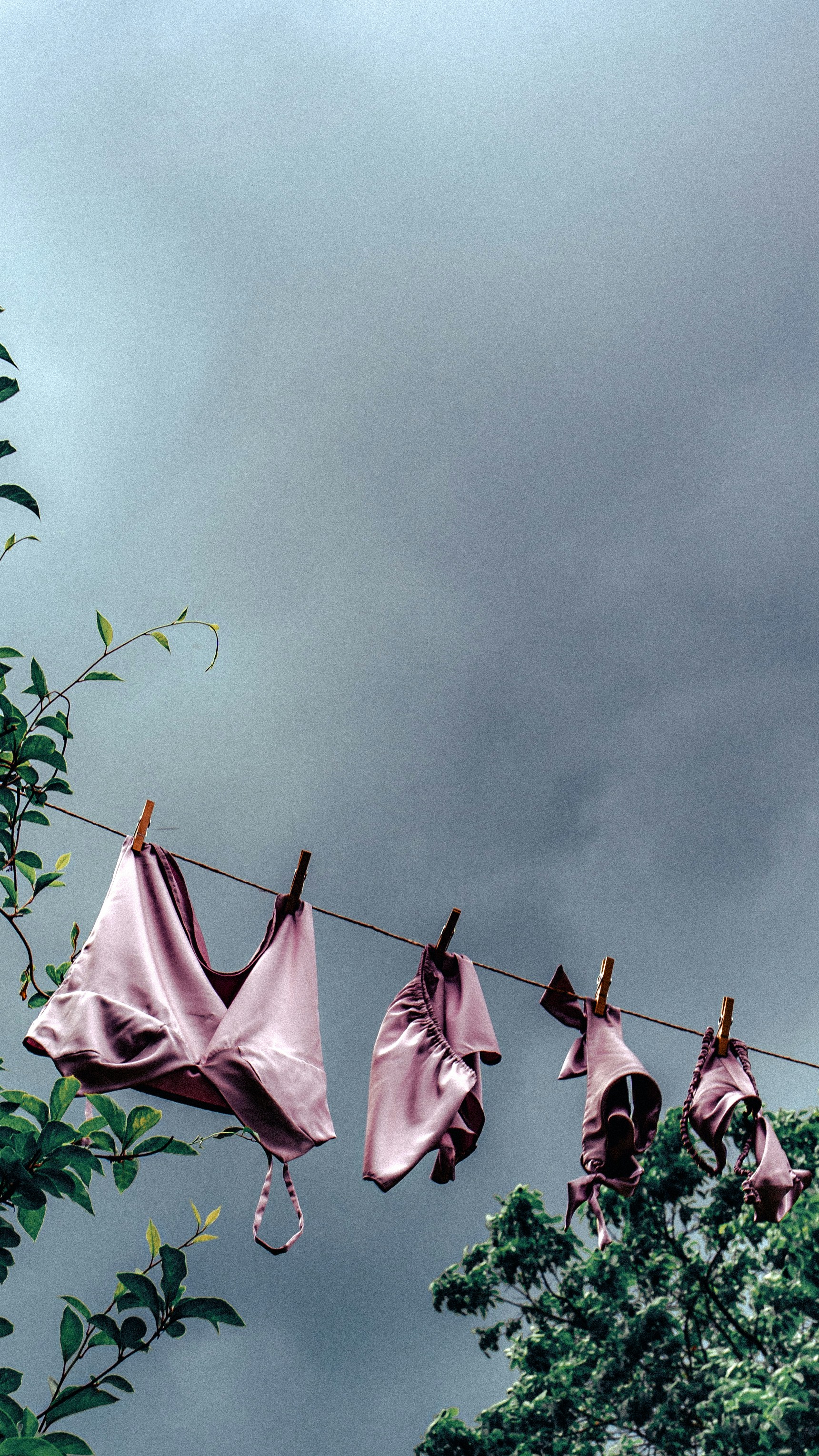 Clothes hanging on a clothes line under a cloudy sky