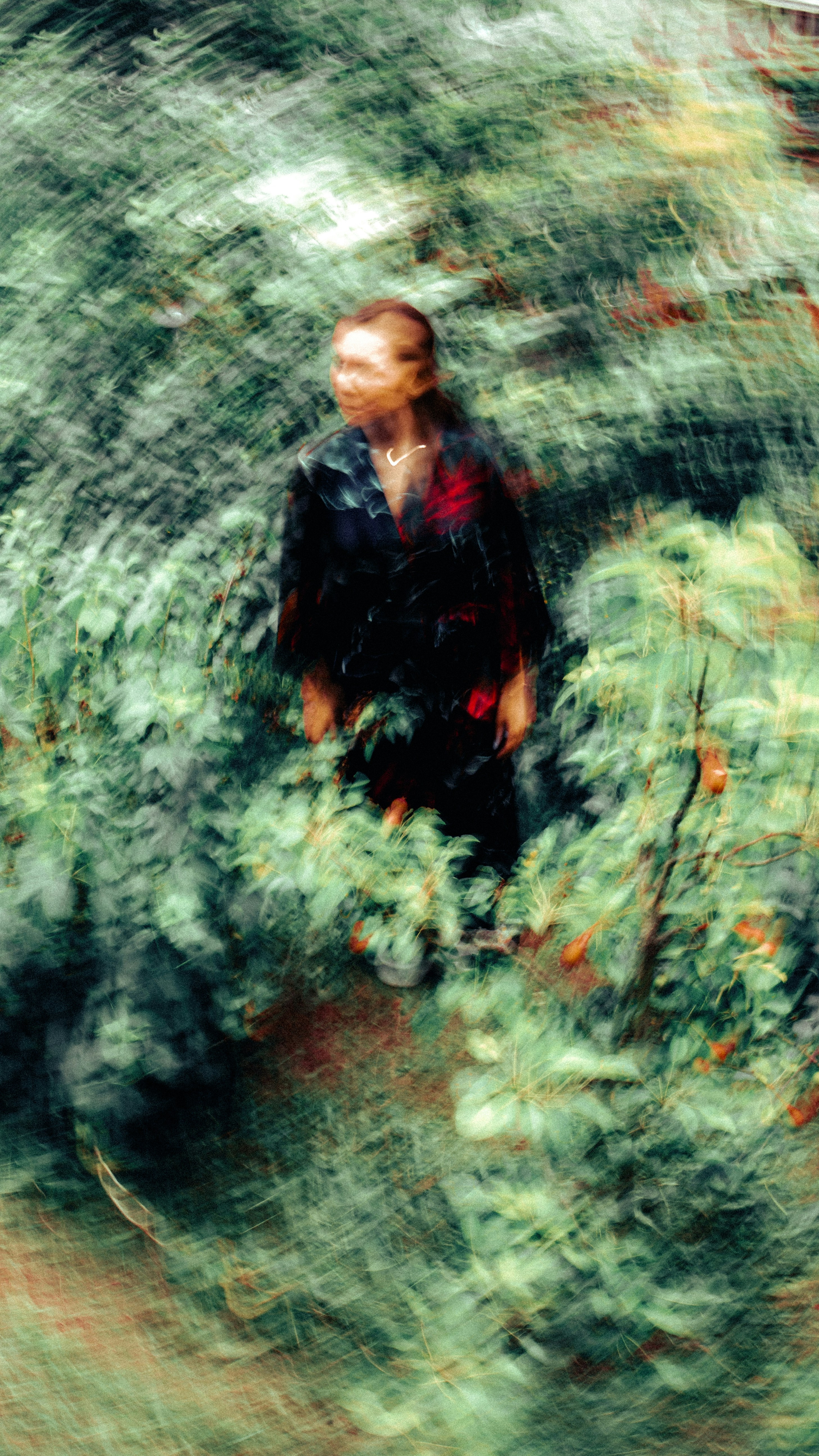A blurry photo of a man walking through a forest