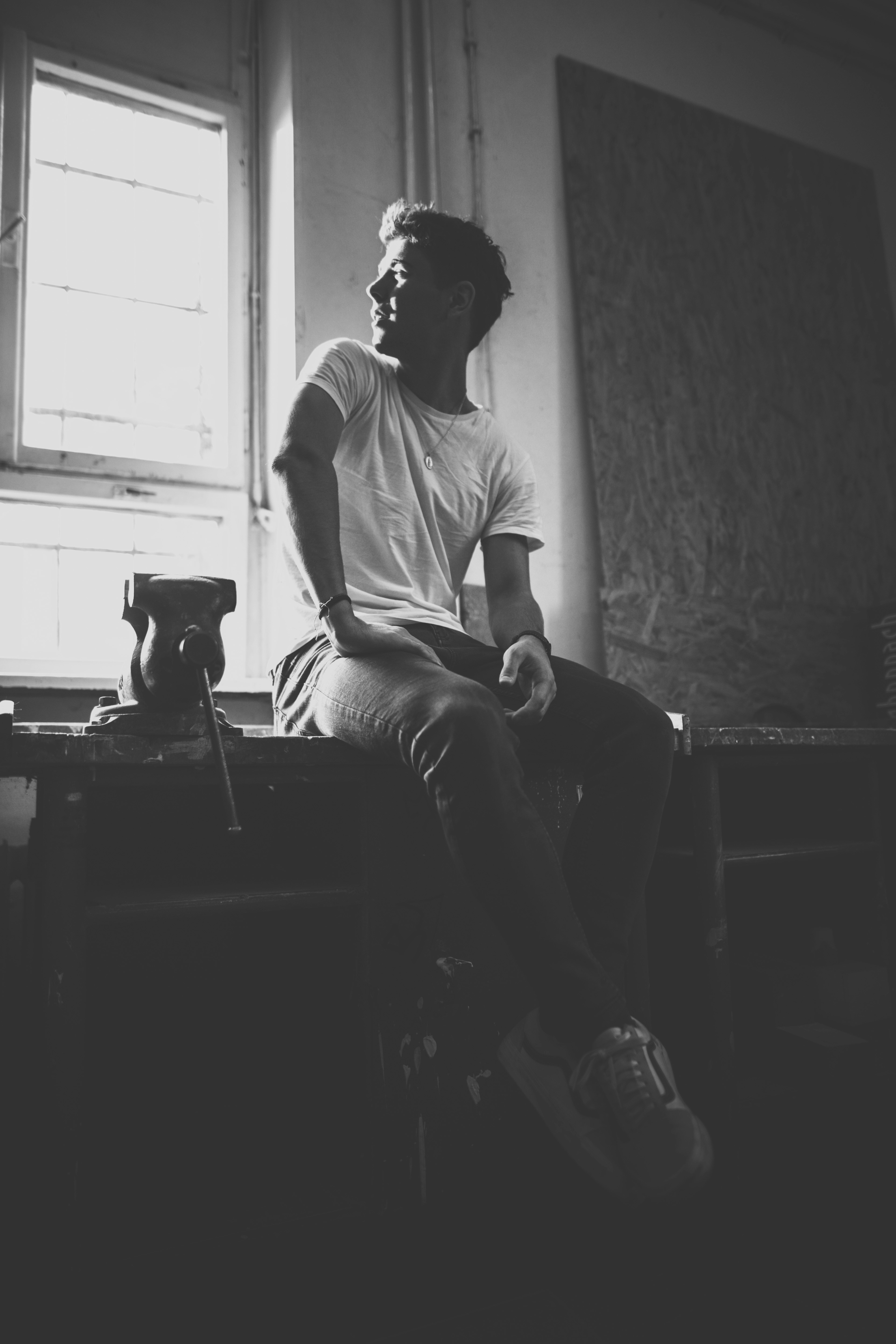 A black and white photo of a man sitting in a chair