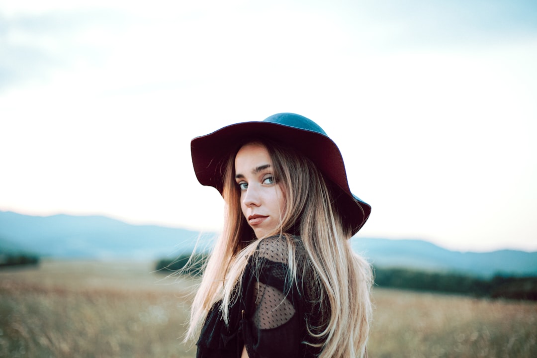 A woman with long blonde hair wearing a hat, Portrait.