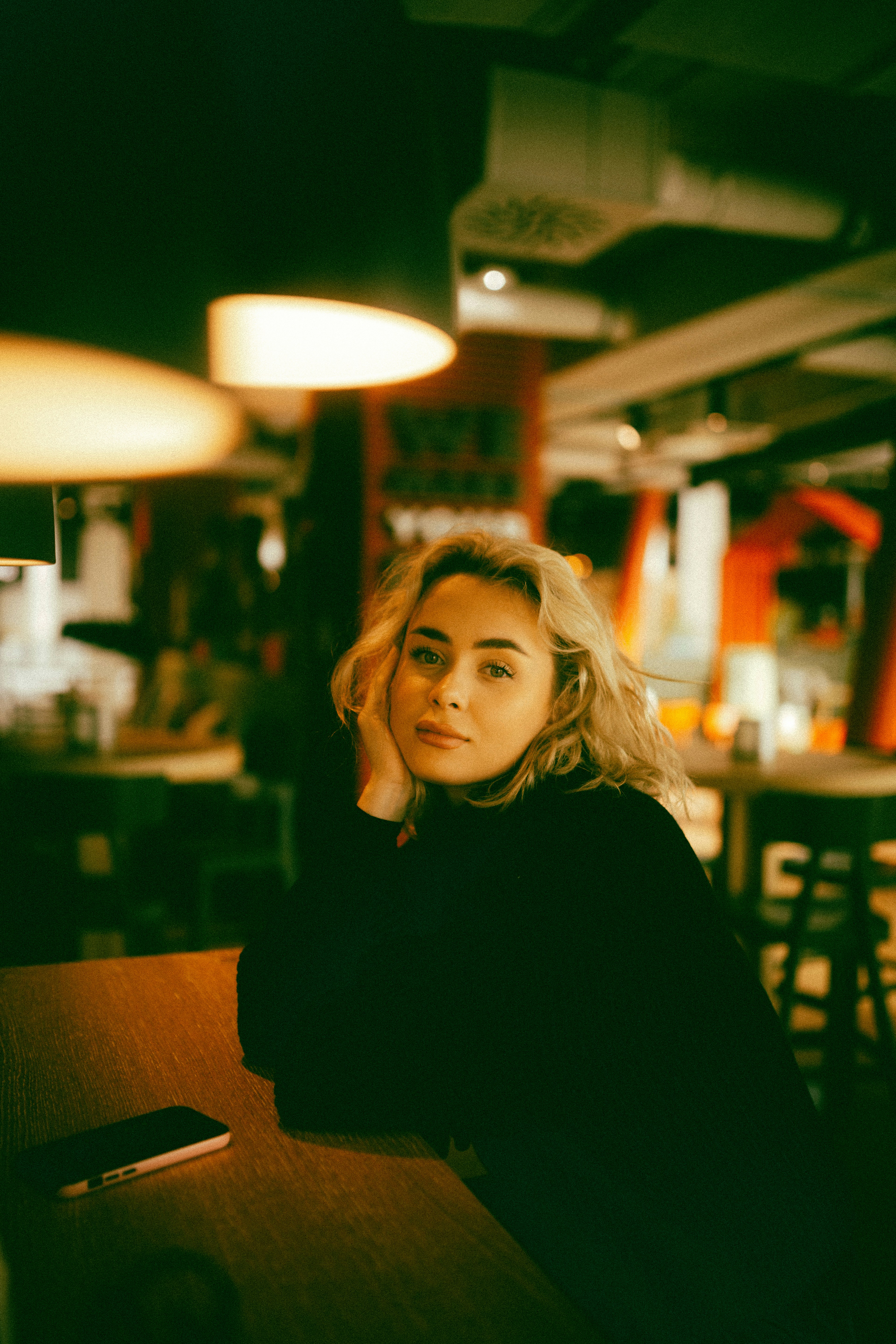 A woman sitting at a table in a restaurant