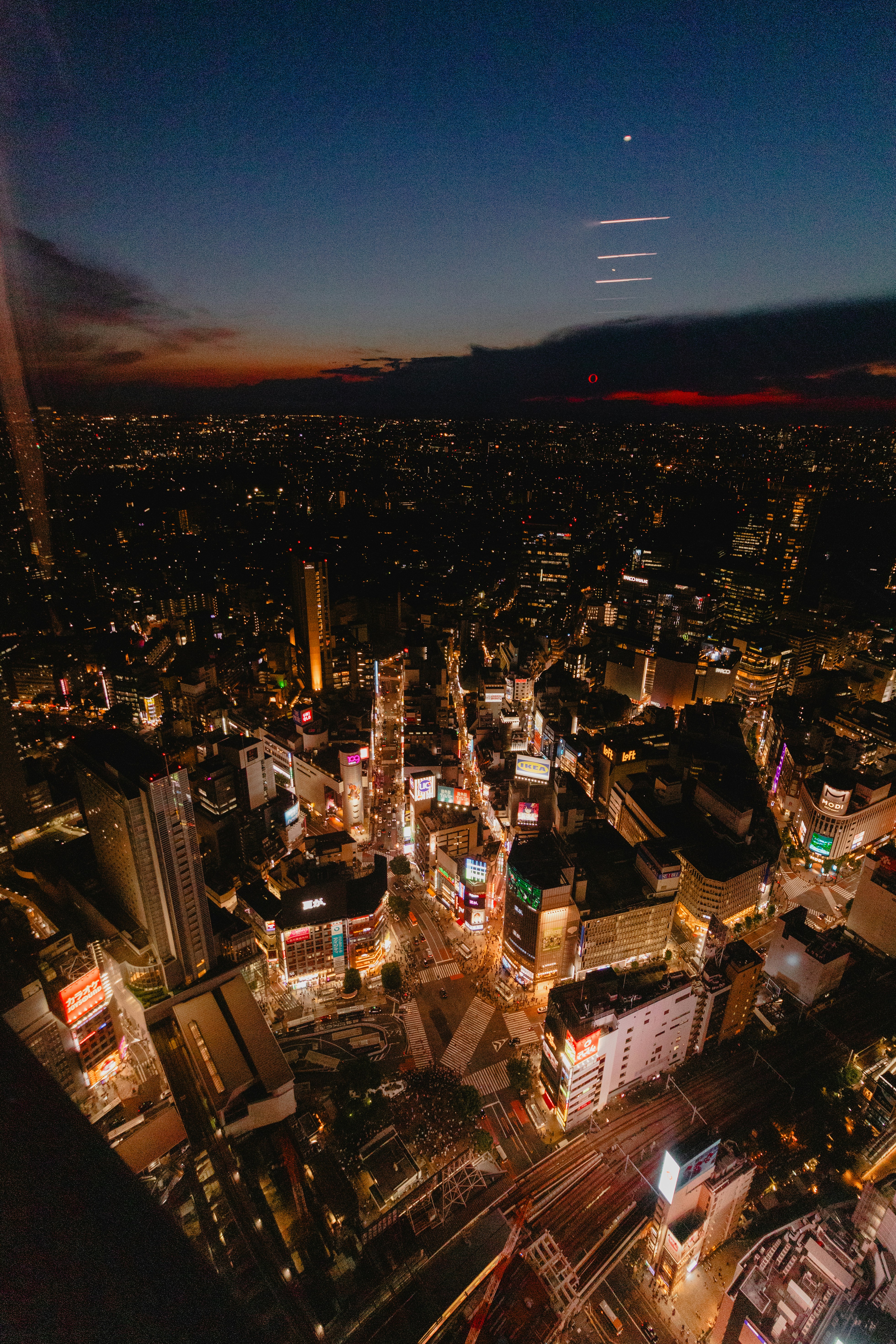 Indian city aerial view at twilight, urban infrastructure, local commerce and community life, dark atmospheric