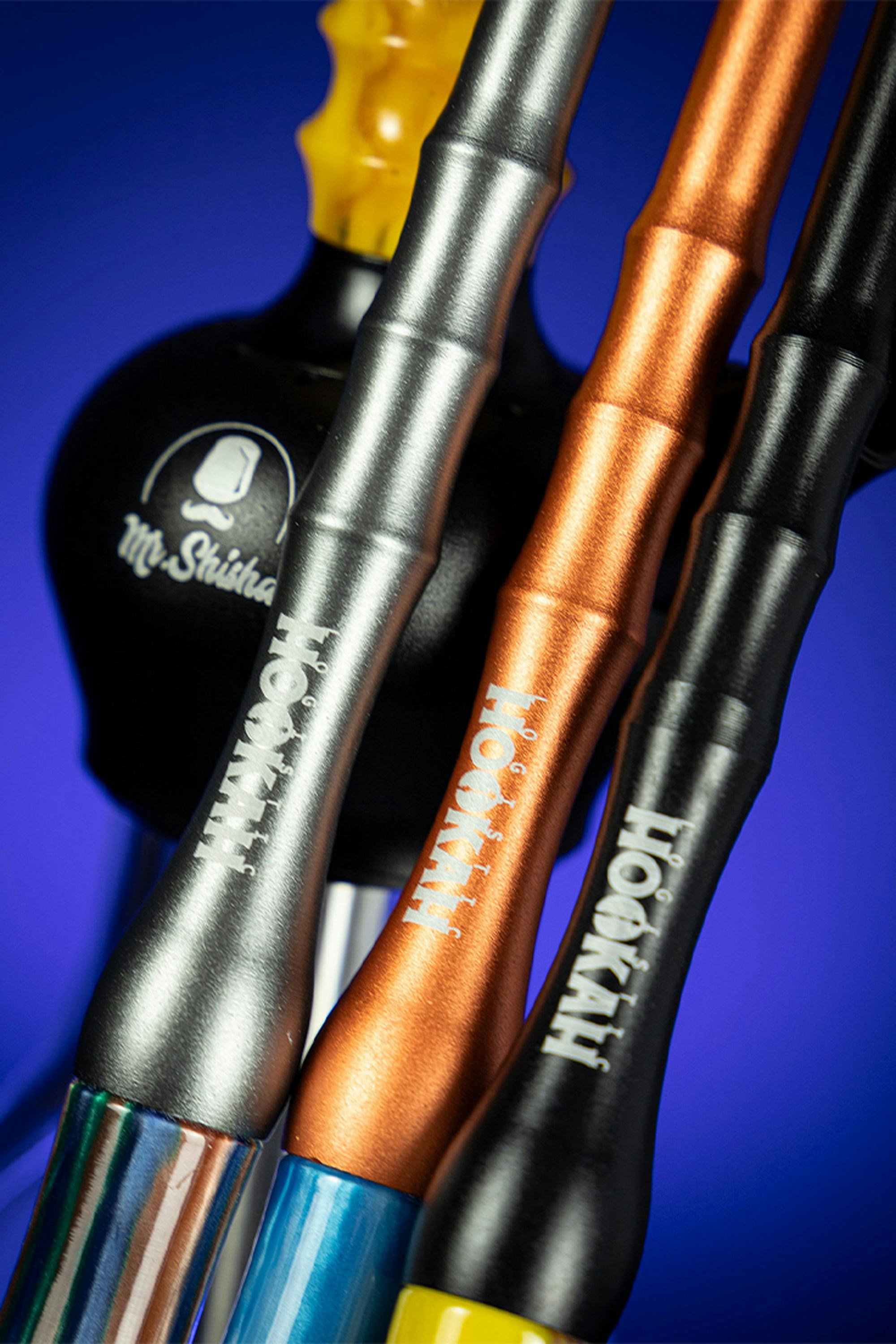 A close up of three different colored toothbrushes