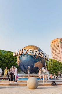 A group of people standing around a giant globe
