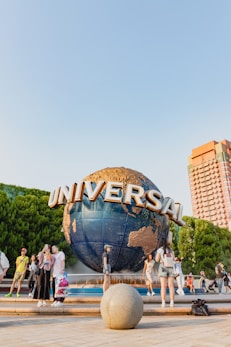 A group of people standing around a giant globe