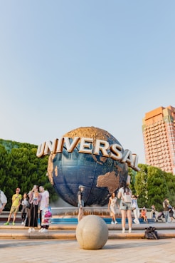 A group of people standing around a giant globe