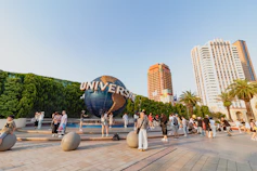 A group of people standing in front of a giant globe