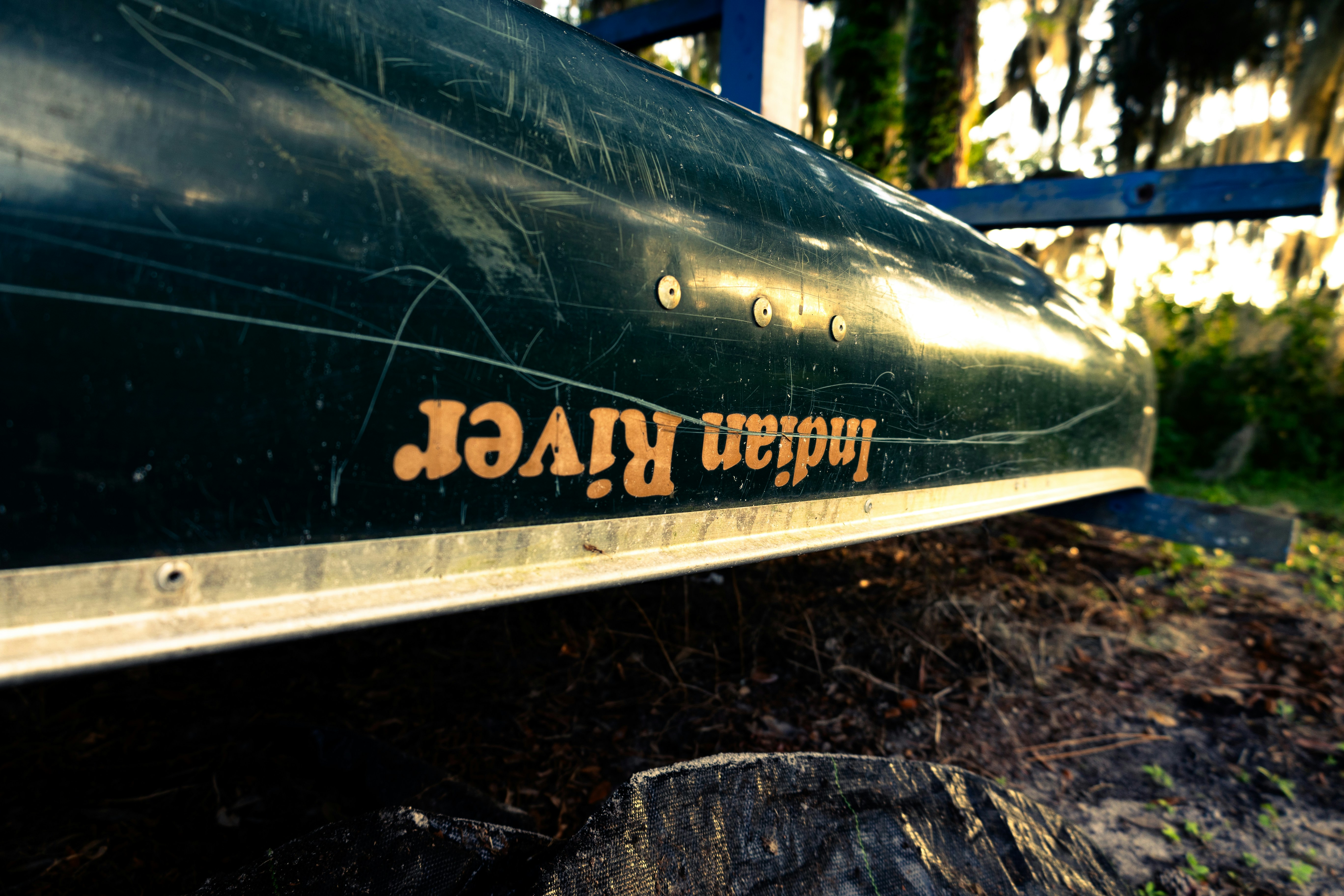 A beat-up canoe at sunset