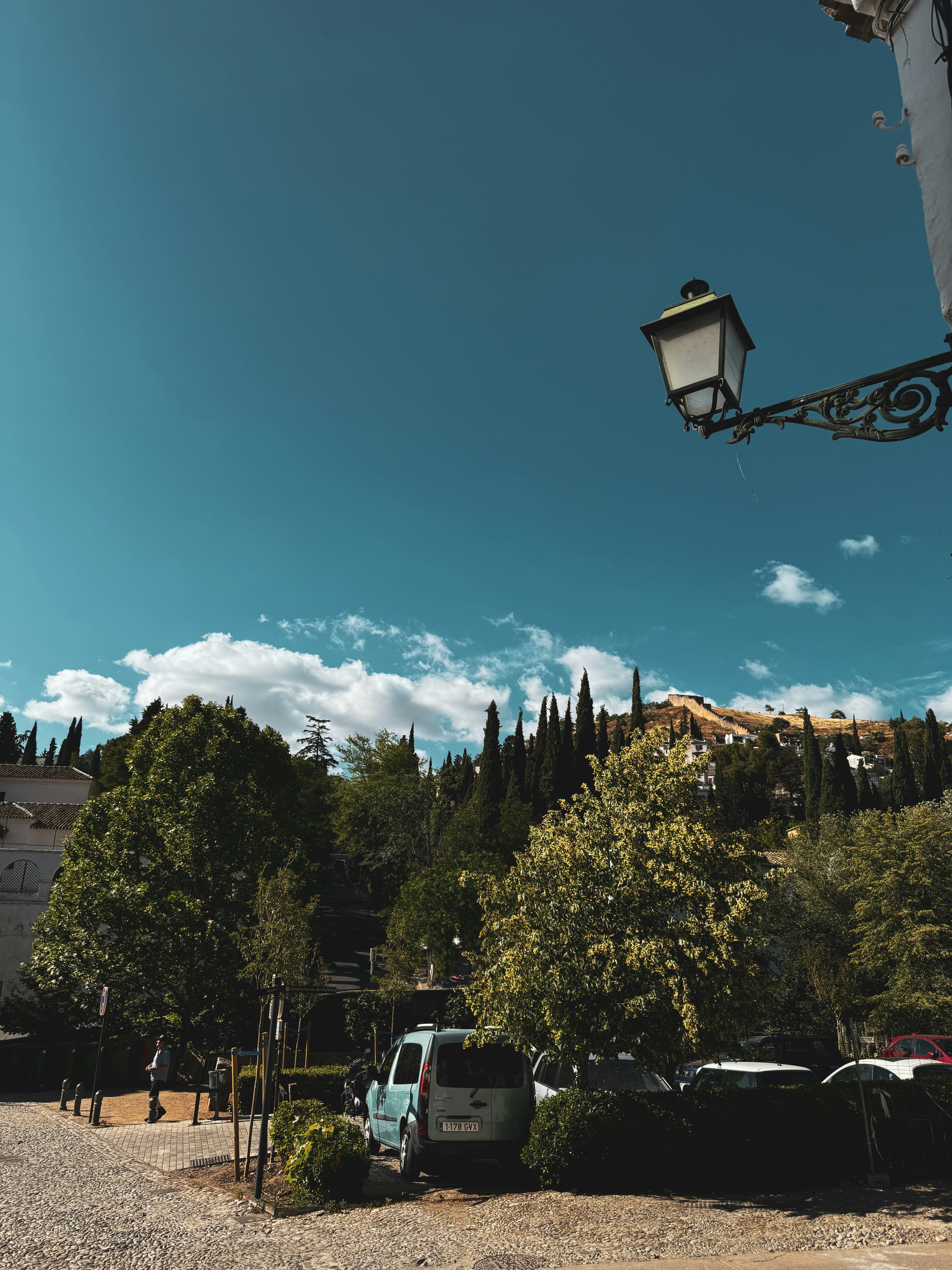 A street light sitting next to a parking lot