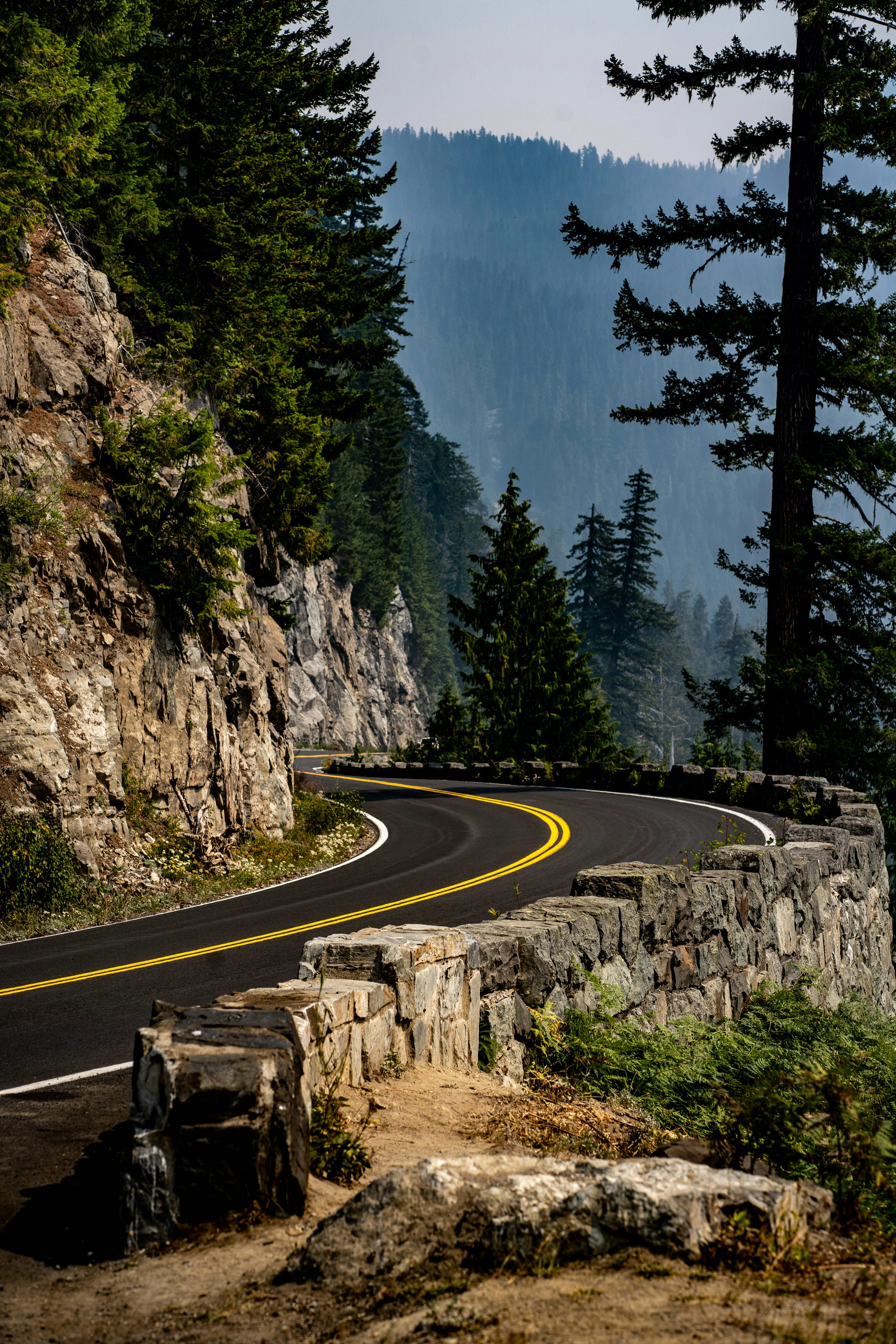 A curved road with a mountain in the background