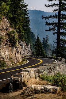 A curved road with a mountain in the background