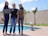 Three women standing in front of a swimming pool