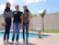 Three women standing in front of a swimming pool