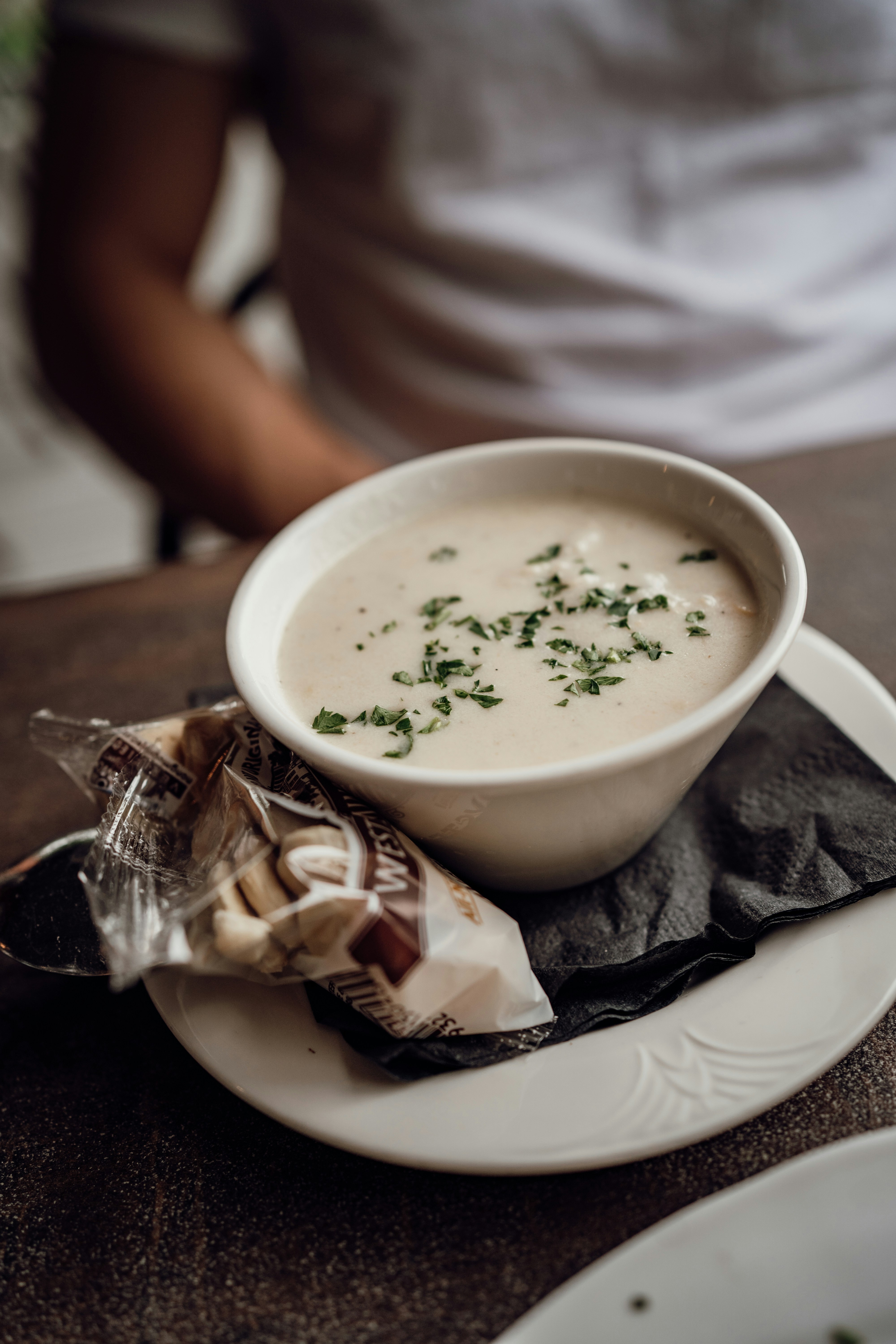 A bowl of soup sitting on top of a white plate