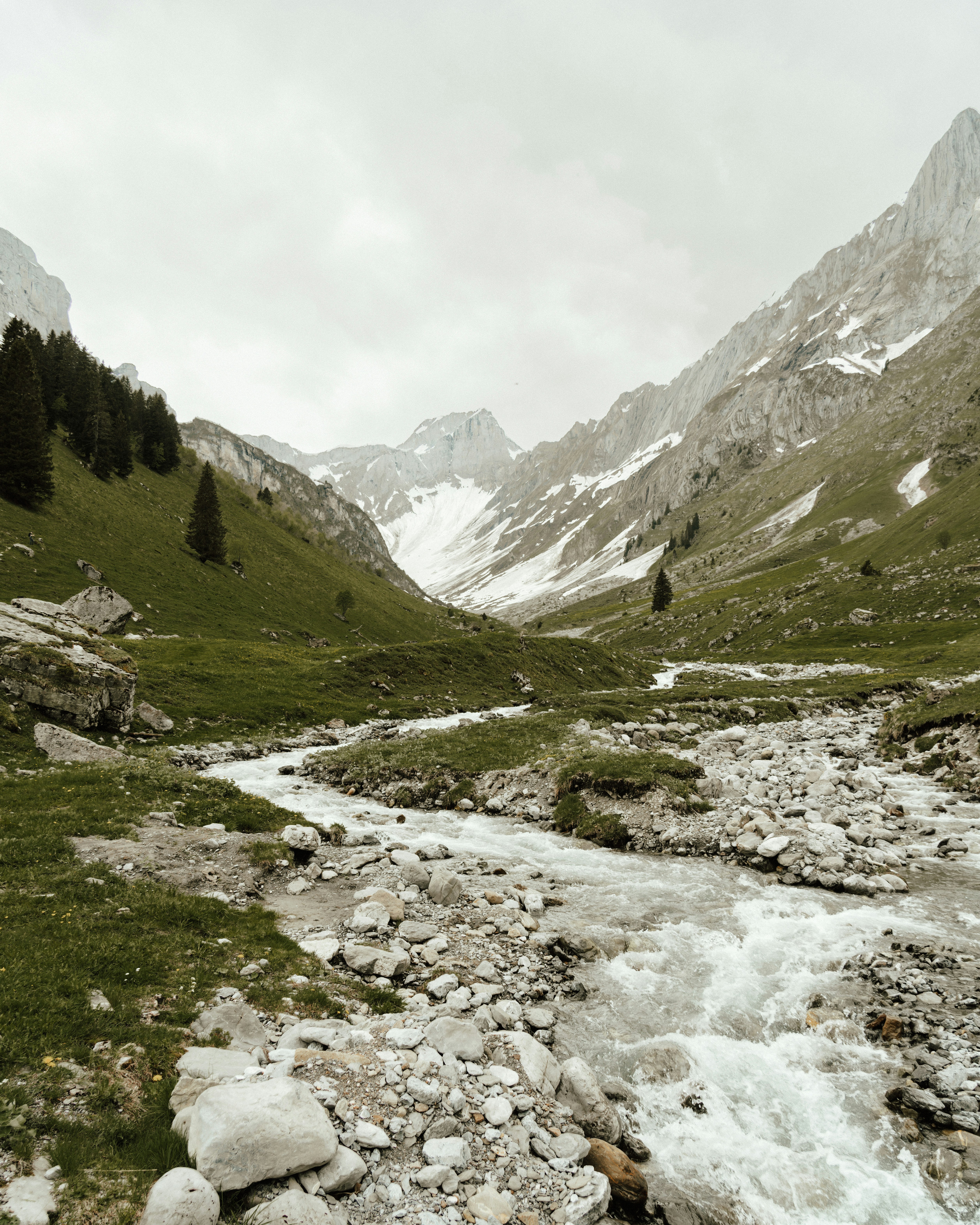 A stream running through a lush green valley
