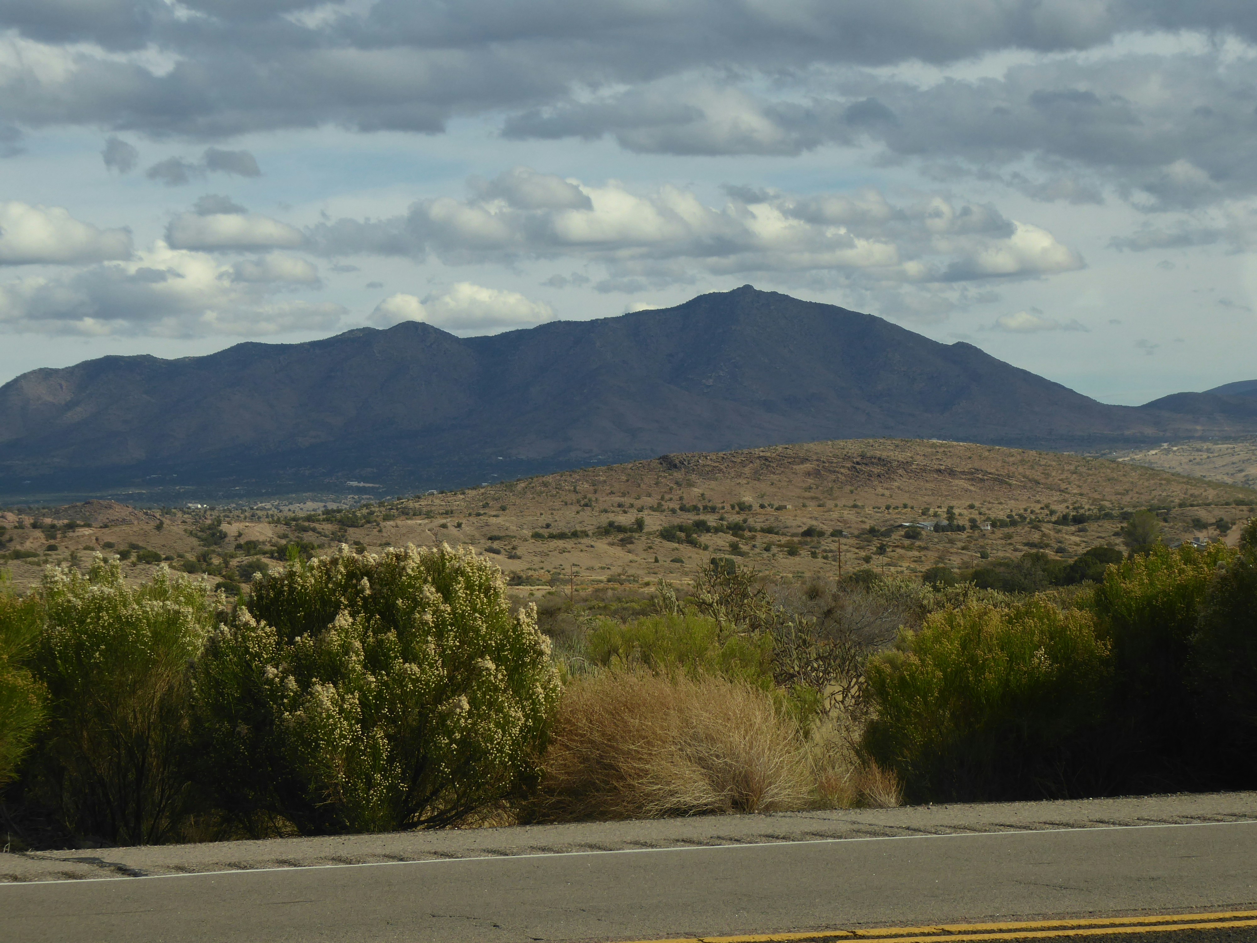 A view of a mountain range from a highway, Mountain background beside road