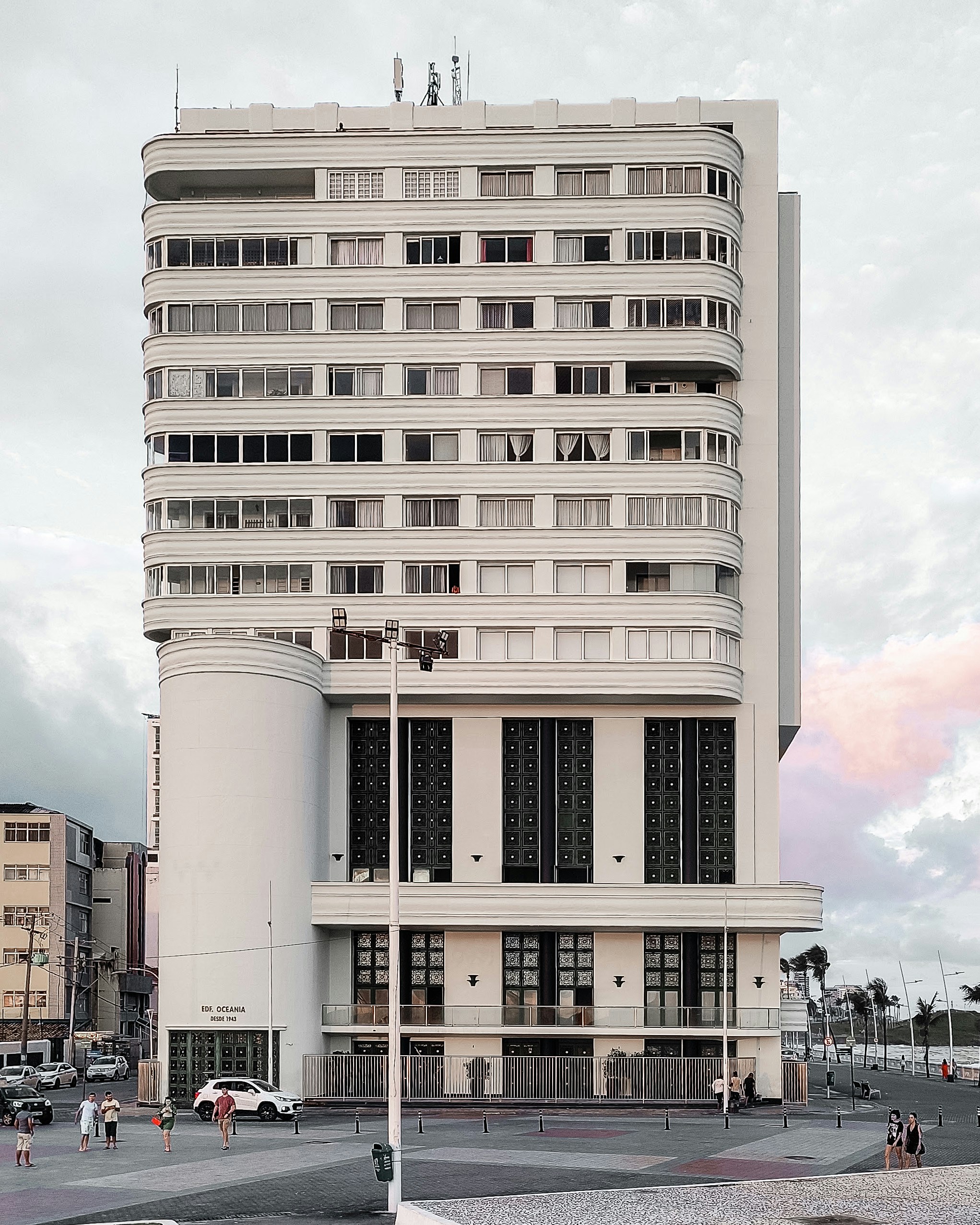 A tall white building sitting on the side of a road