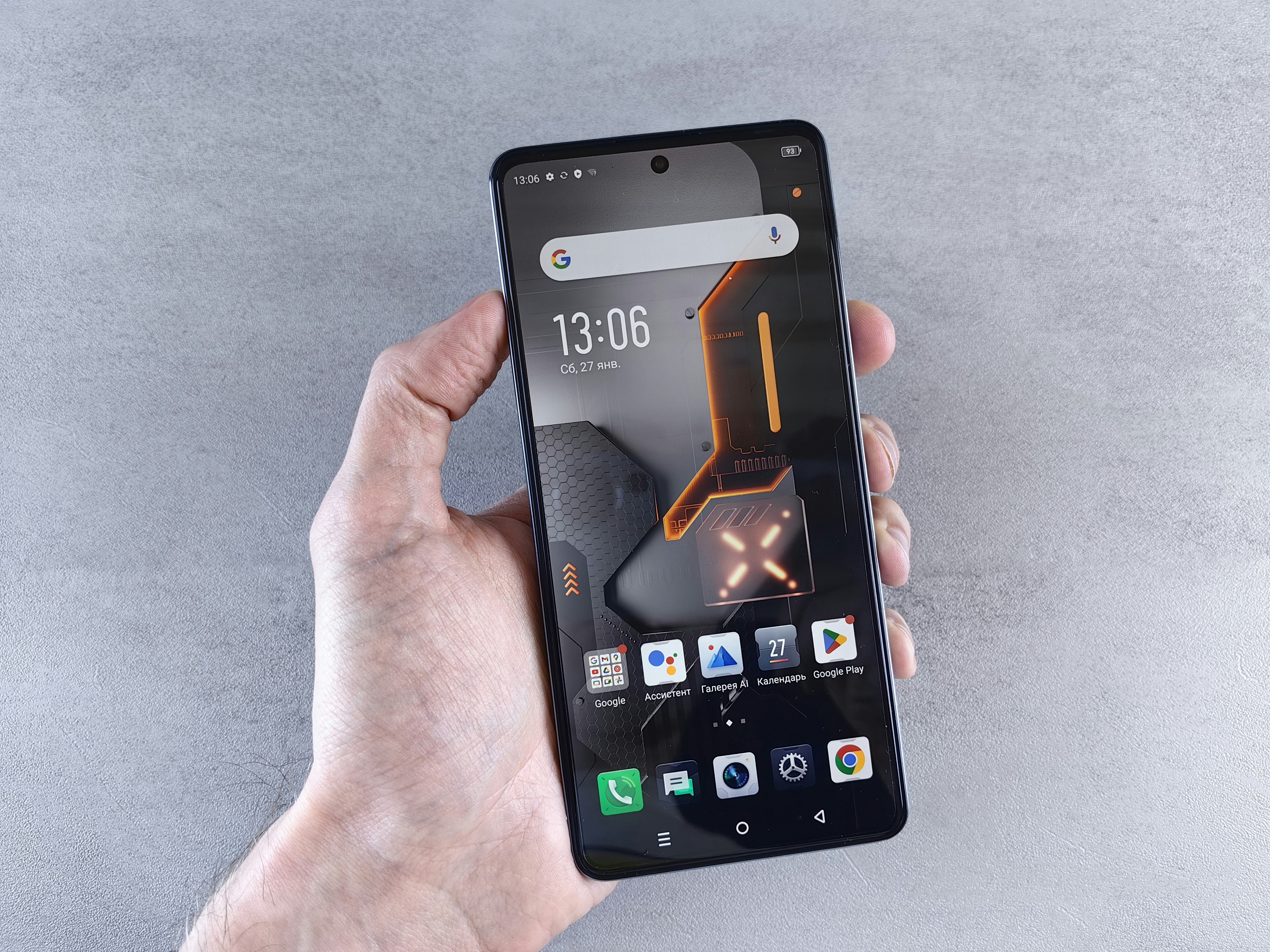 Hand holding an Android smartphone with Google Play on screen