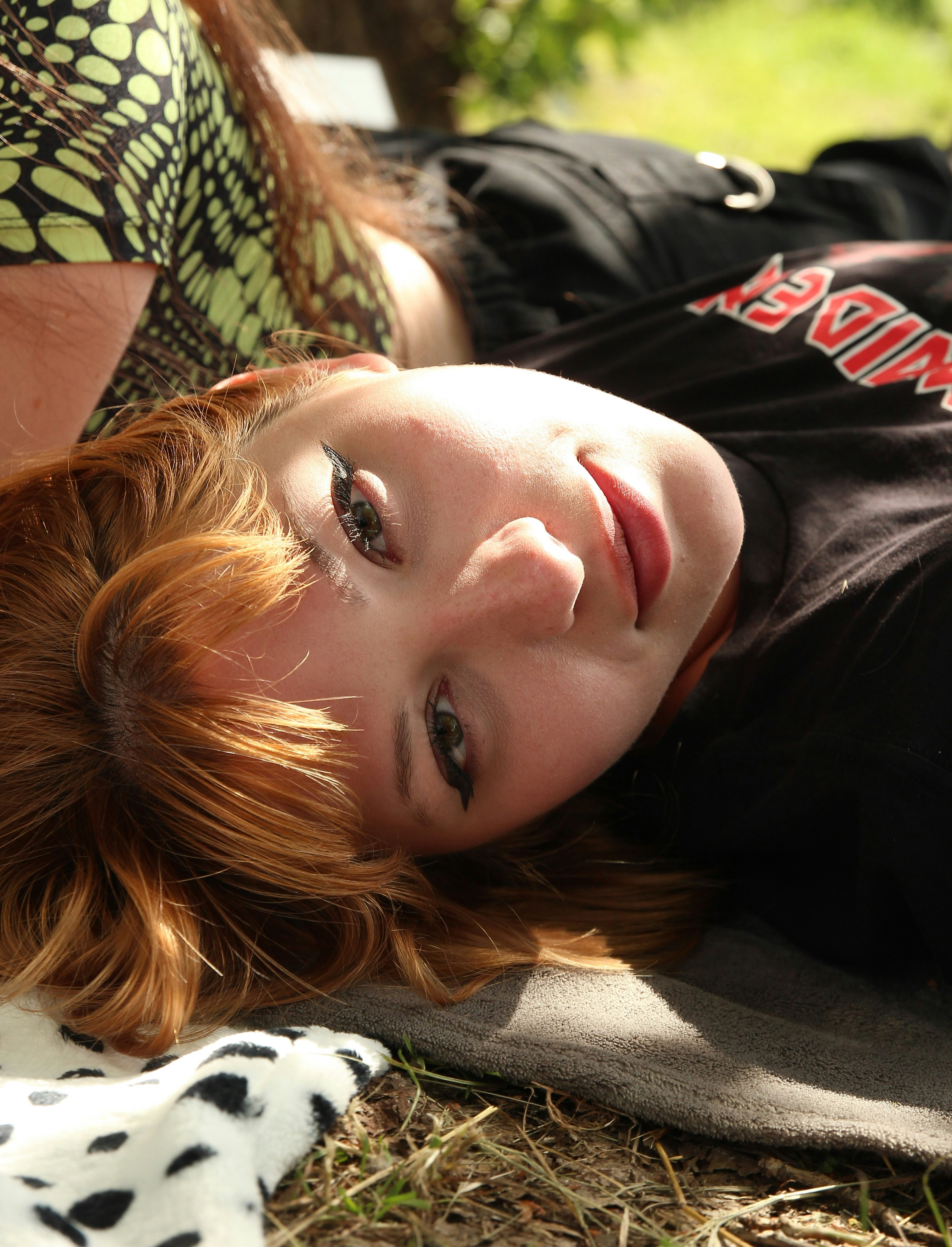 A woman laying on the ground with her eyes closed