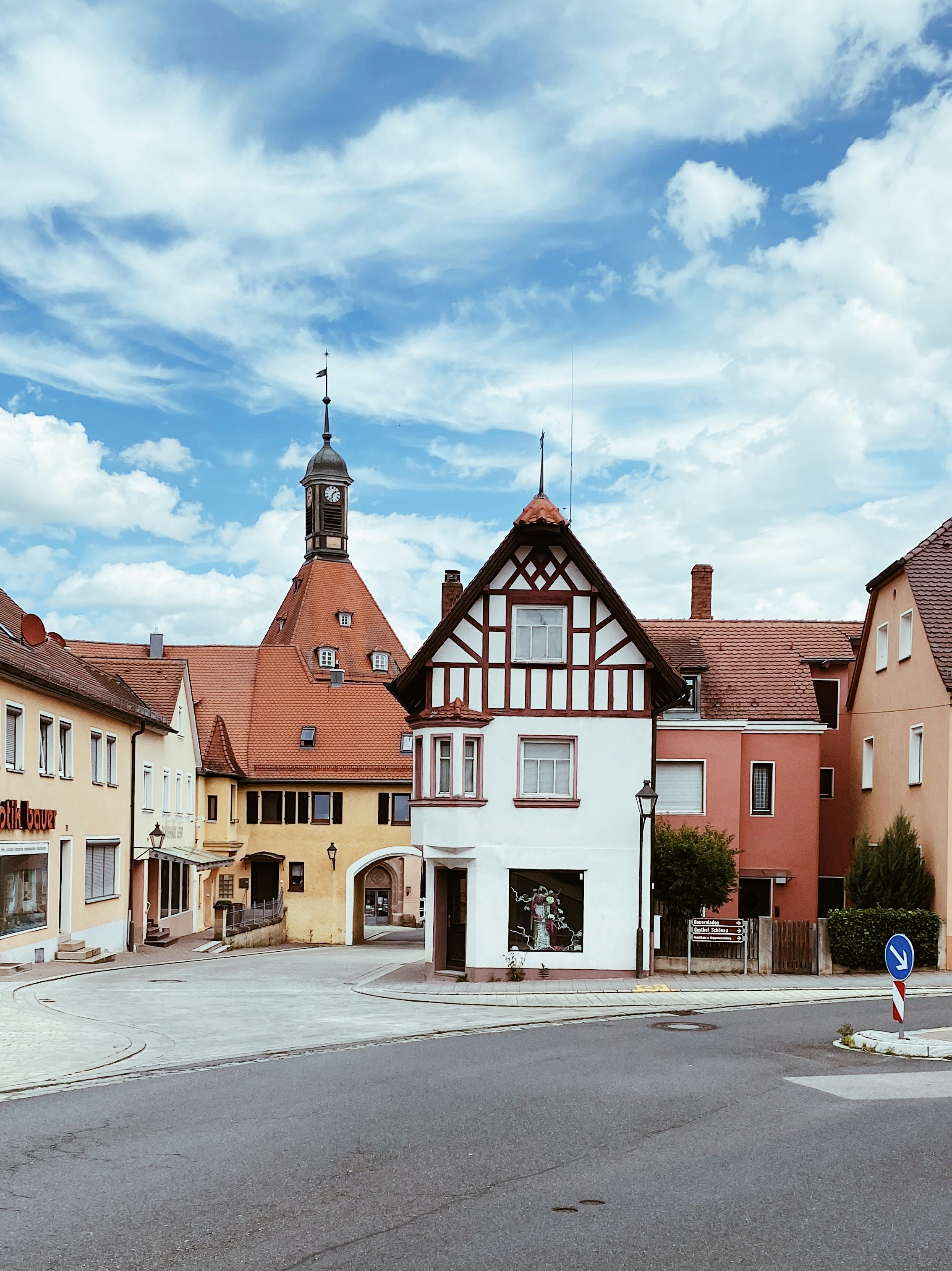Eine Straßenecke mit Gebäuden und einem Uhrenturm im Hintergrund