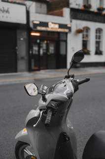 A motor scooter parked on the side of the road