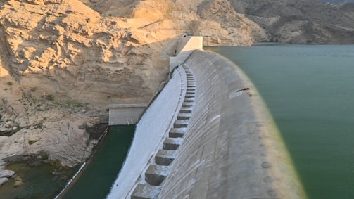 A large body of water next to a mountain