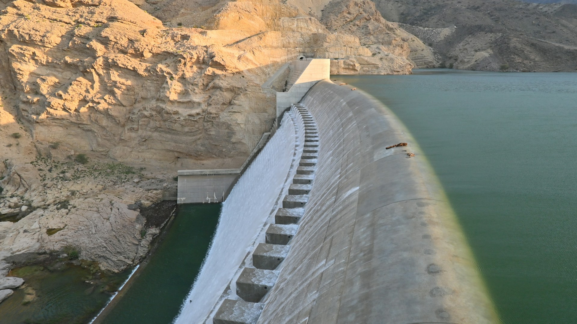 A large body of water next to a mountain