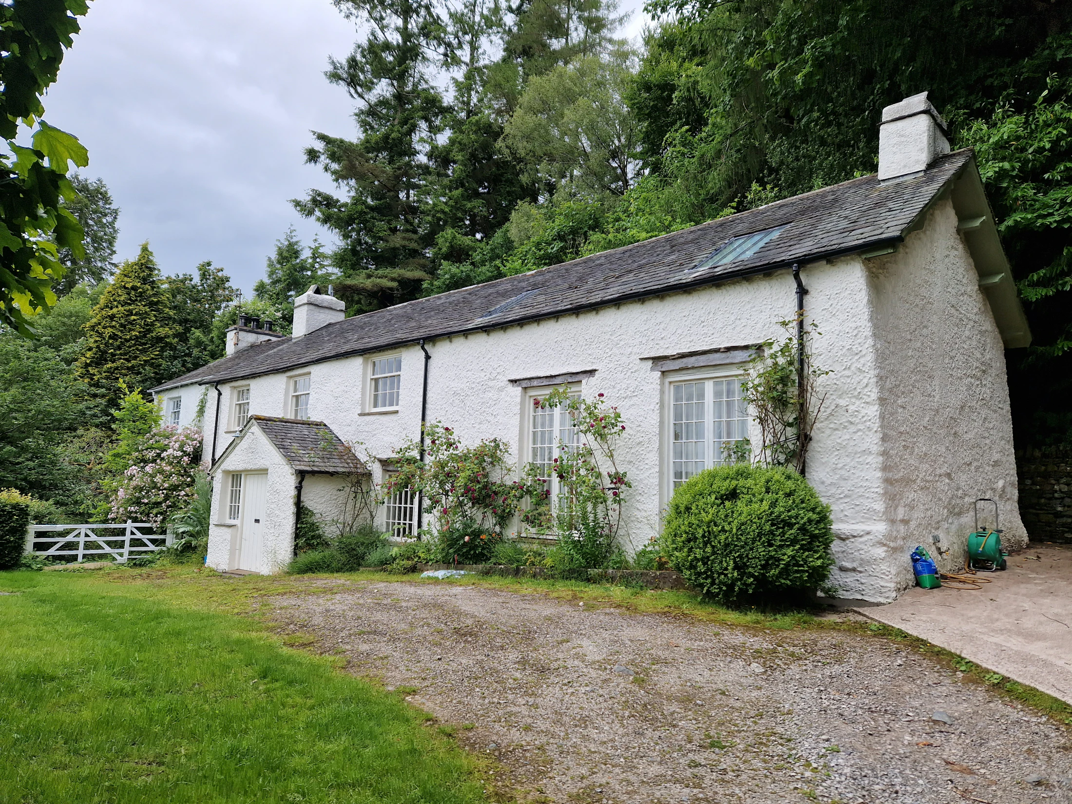 A white holiday property on a green hillside