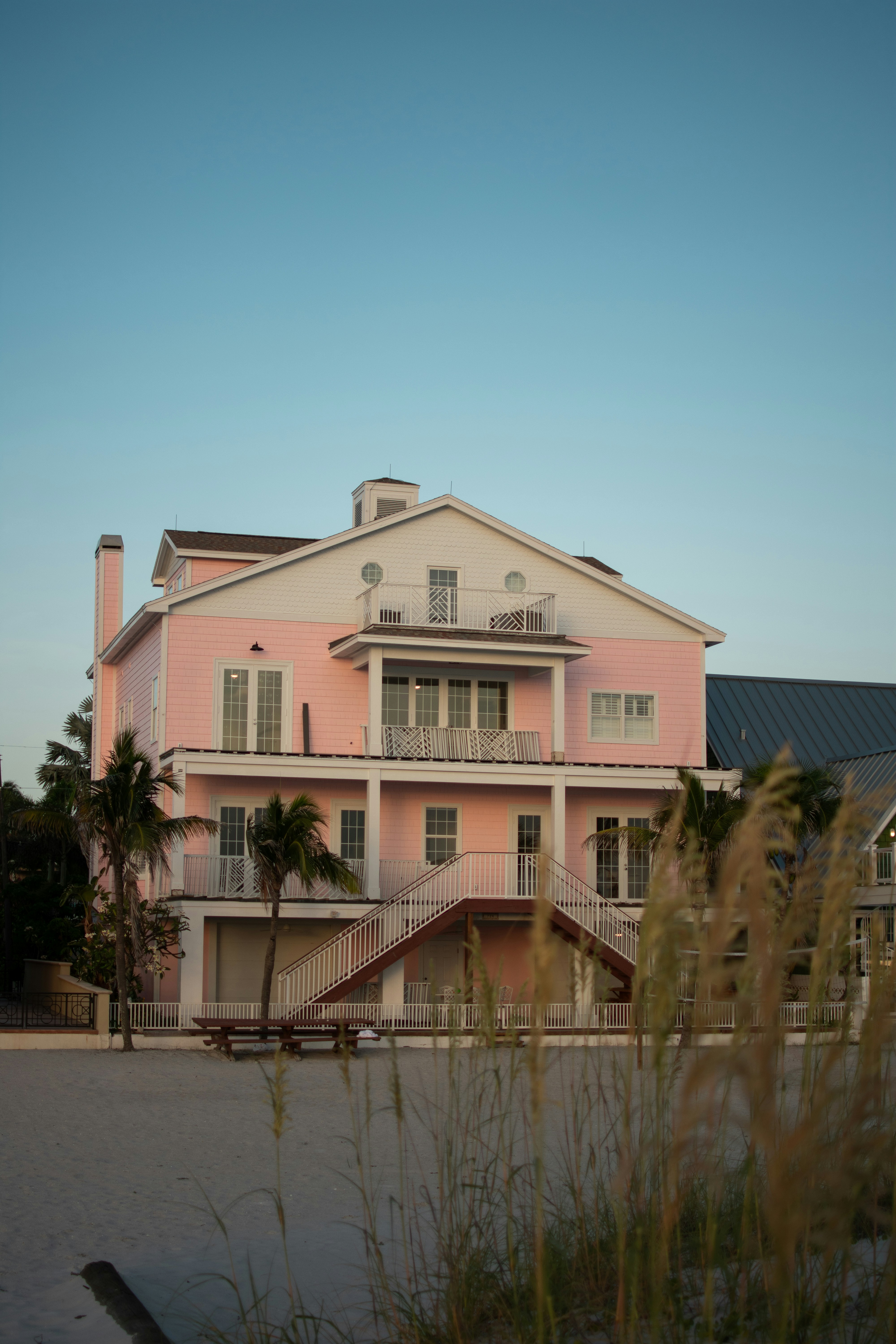 A pink house with a bench in front of it