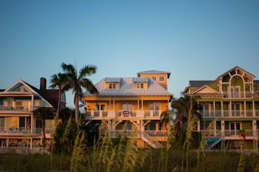 A row of houses sitting on top of a lush green field