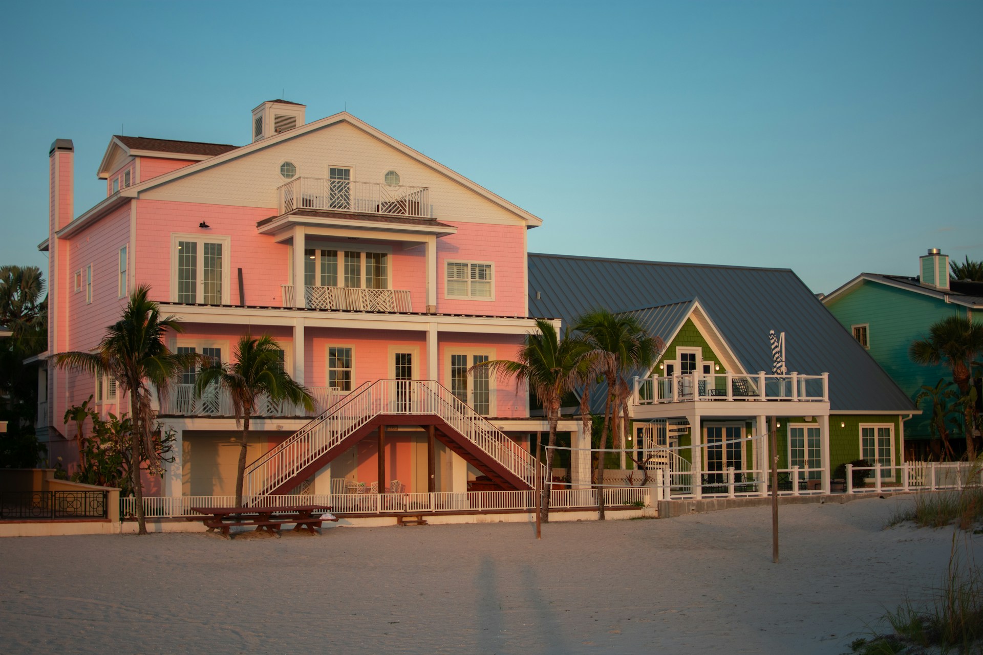 A large pink house sitting on the side of a road