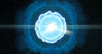 A blue ball of light in the middle of a black background