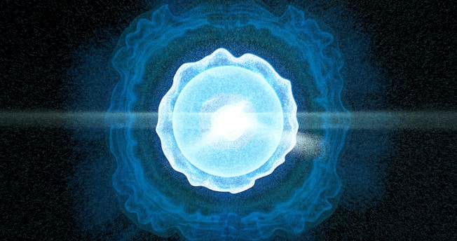 A blue ball of light in the middle of a black background