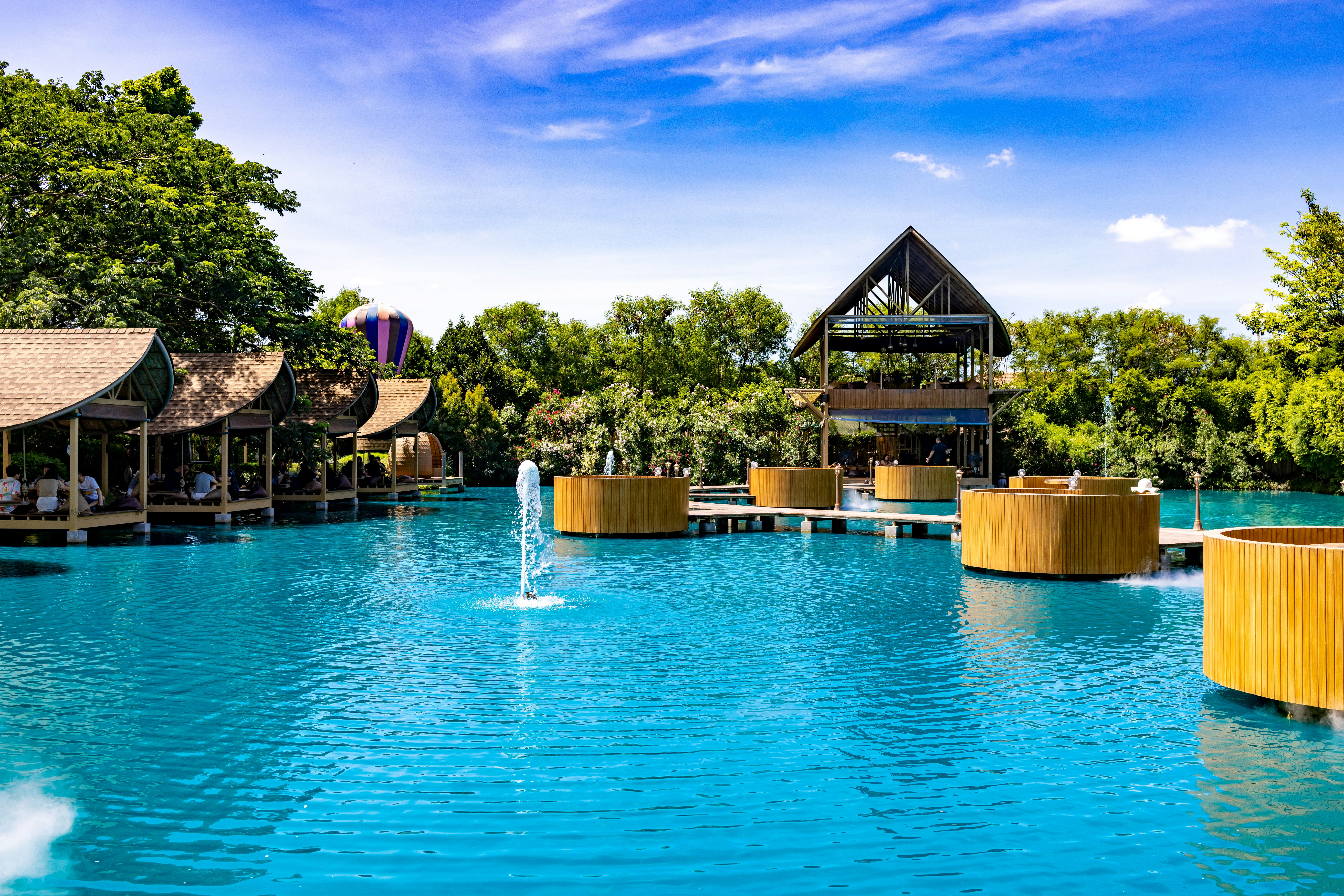 A large swimming pool surrounded by trees, 