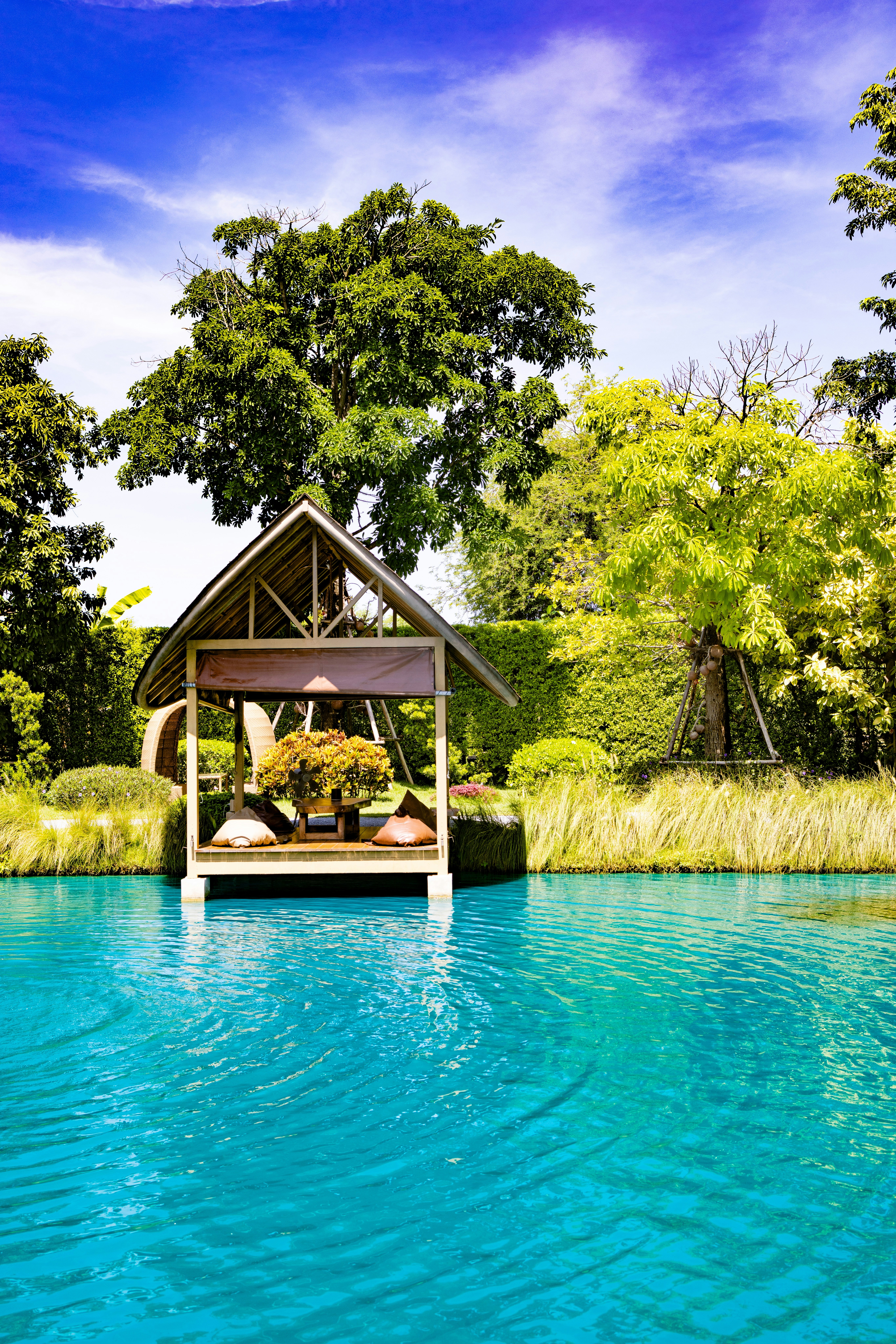 Outdoor swimming pool area with sun terrace and garden seating at Majestic Haven Guesthouse