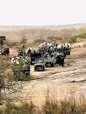 A group of people riding on the back of four wheelers