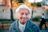 An old woman is walking down the street