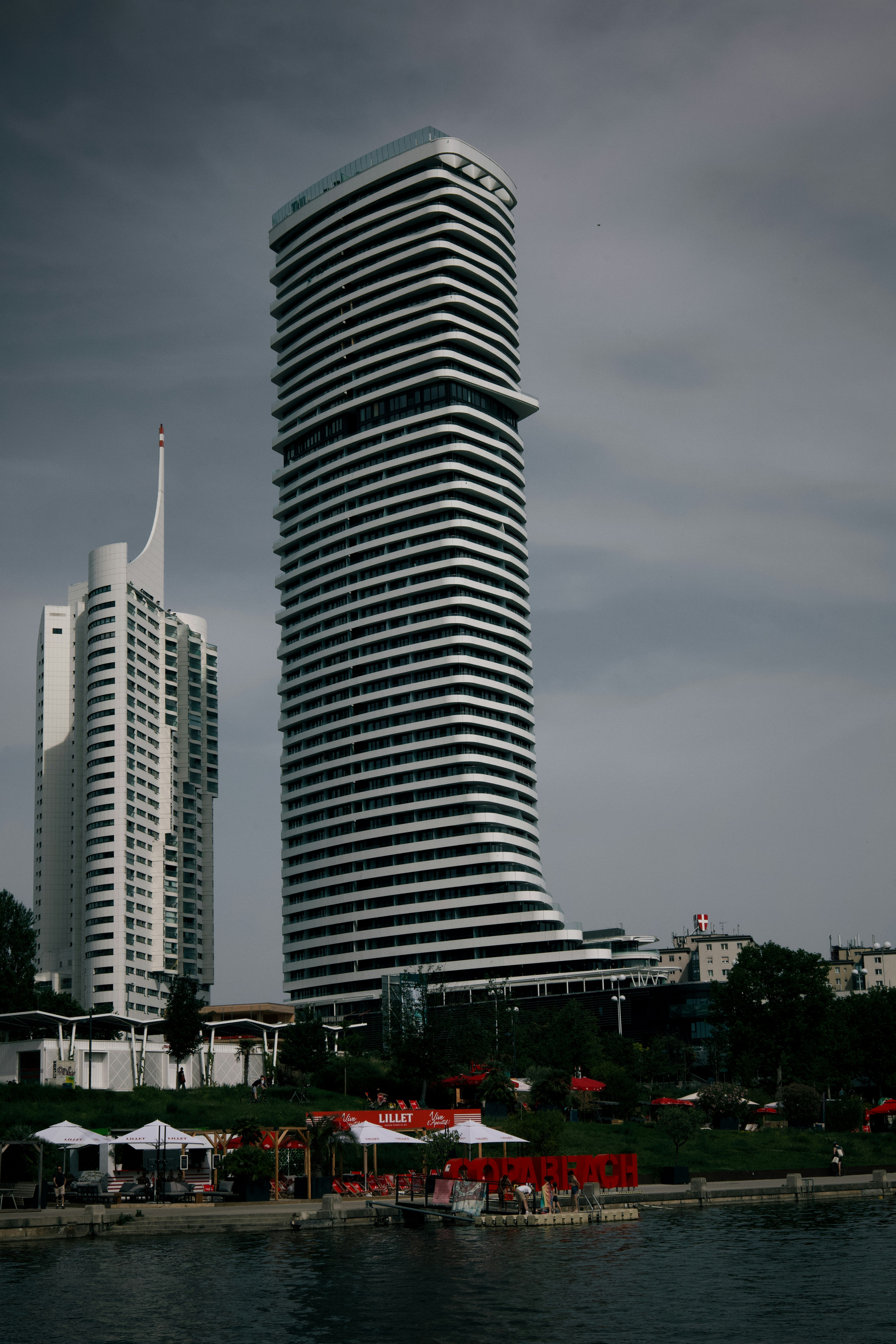 A tall building sitting next to a body of water