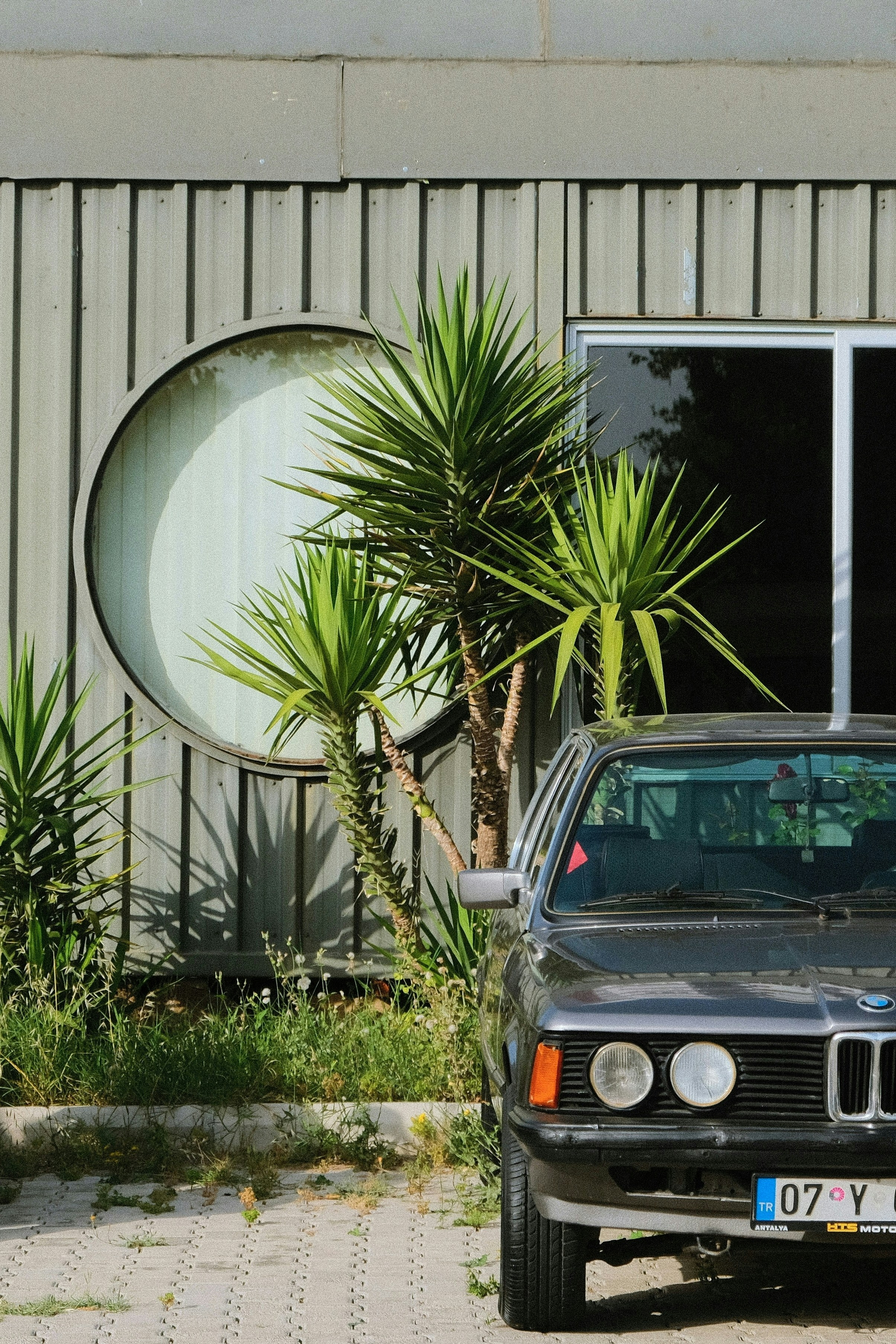 A black car parked in front of a building