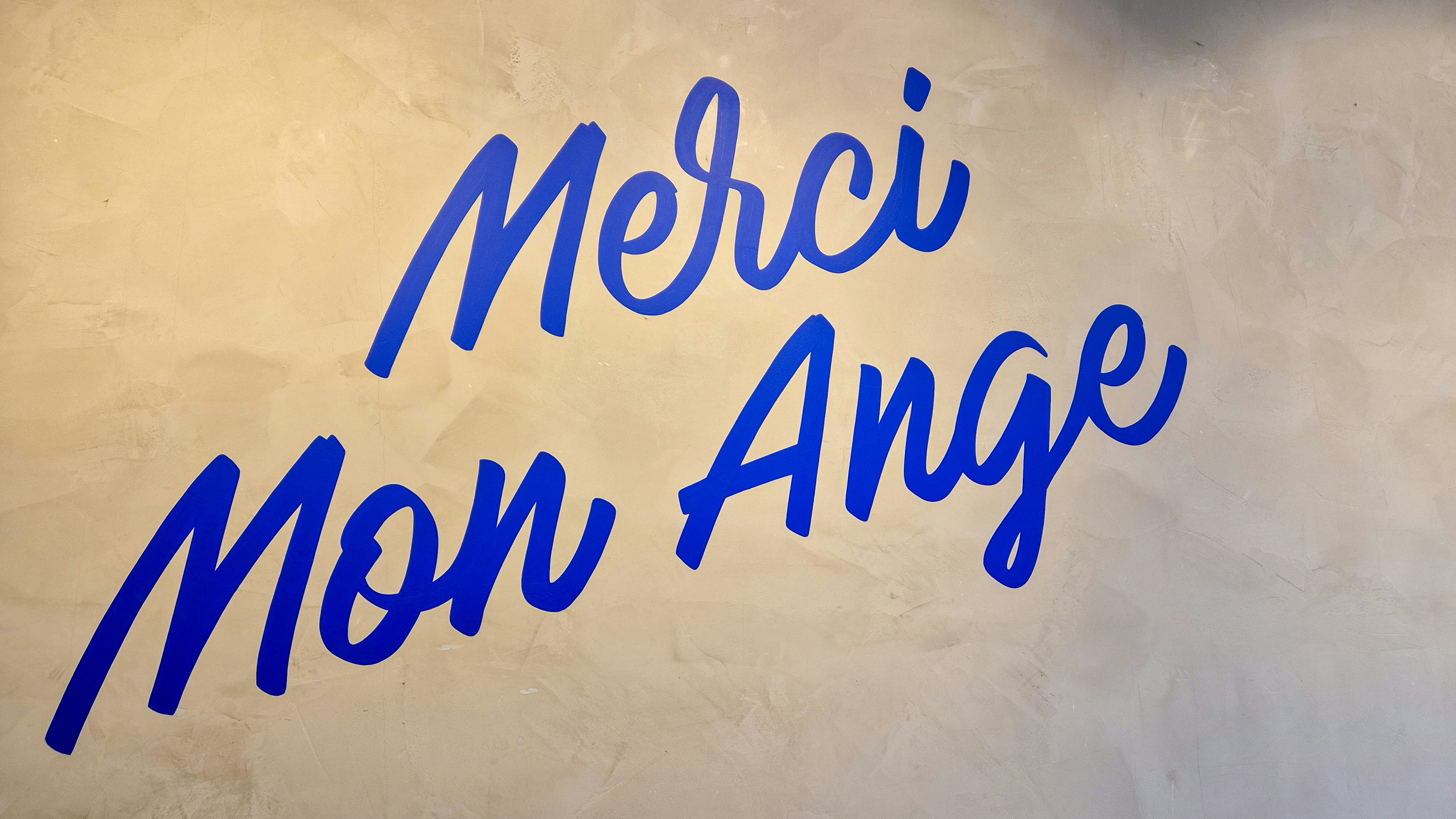 A white wall with blue writing on it