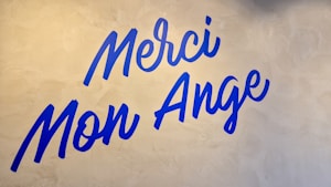 A white wall with blue writing on it